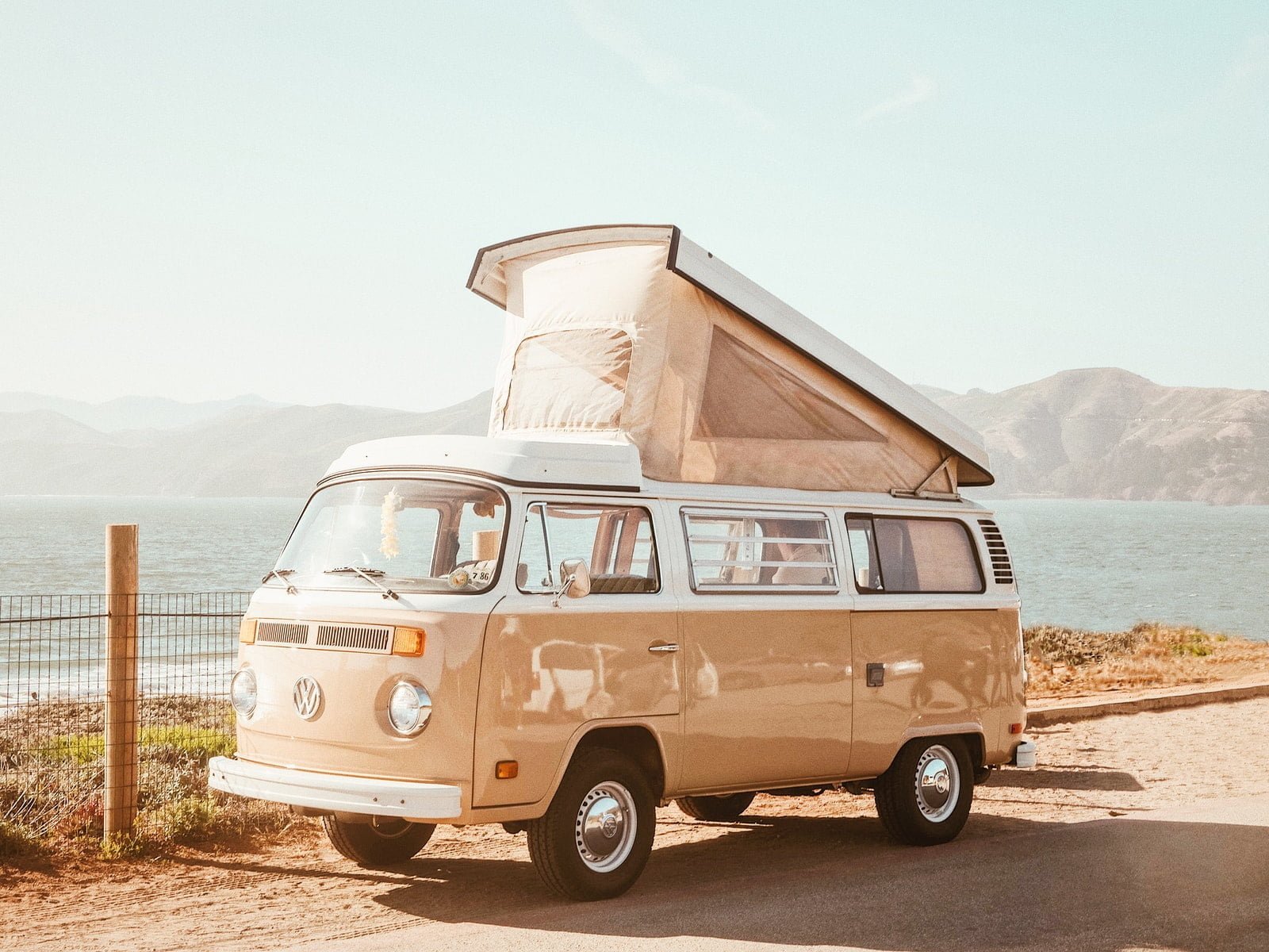 brown Volkswagen T1 van near body of water at daytime