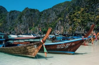 two brown boats in body of water