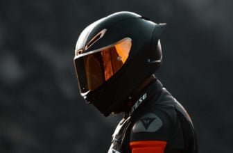 black and orange helmet on black motorcycle